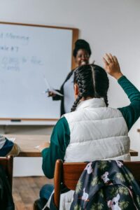 Student raising hand in class